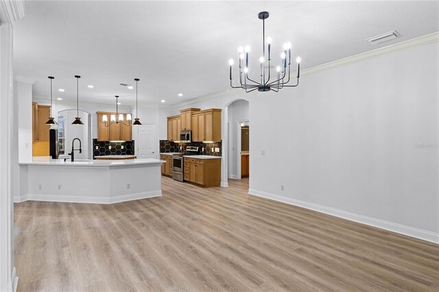 674 Whisper Woods Dr, Lakeland, FL 33813 - kitchen with a sink, stainless steel appliances, arched walkways, and open floor plan