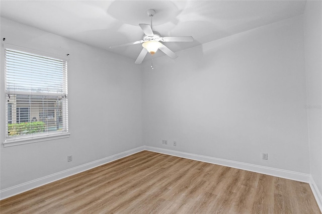 674 Whisper Woods Dr, Lakeland, FL 33813 - spare room featuring light wood finished floors, plenty of natural light, a ceiling fan, and baseboards
