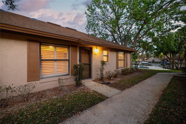 exterior entry at dusk with stucco siding