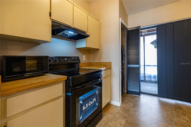 kitchen with butcher block counters, black appliances, a textured ceiling, under cabinet range hood, and baseboards