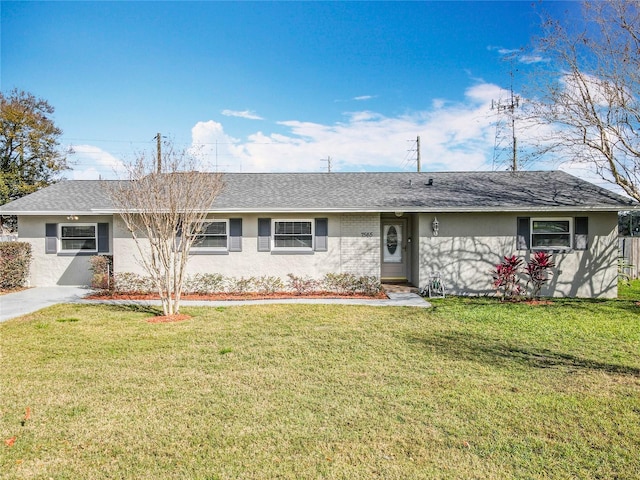 single story home with a front yard, roof with shingles, and stucco siding