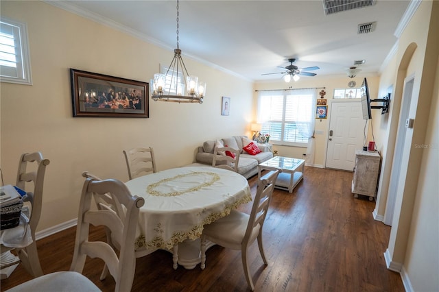 dining room featuring visible vents, baseboards, ornamental molding, and dark wood-style flooring