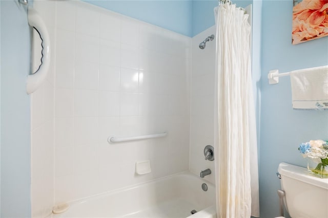 bathroom with toilet and shower / tub combo with curtain