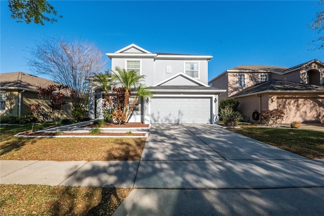 traditional-style home featuring a garage, concrete driveway, and stucco siding