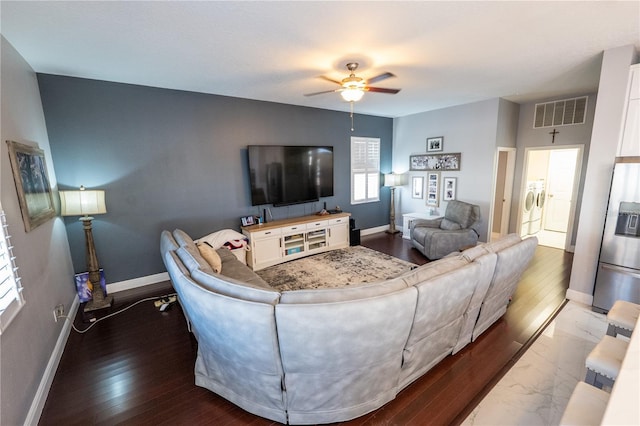 living area with marble finish floor, washer and clothes dryer, visible vents, ceiling fan, and baseboards