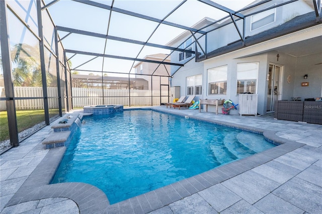 view of swimming pool featuring a pool with connected hot tub, a lanai, a patio, and fence