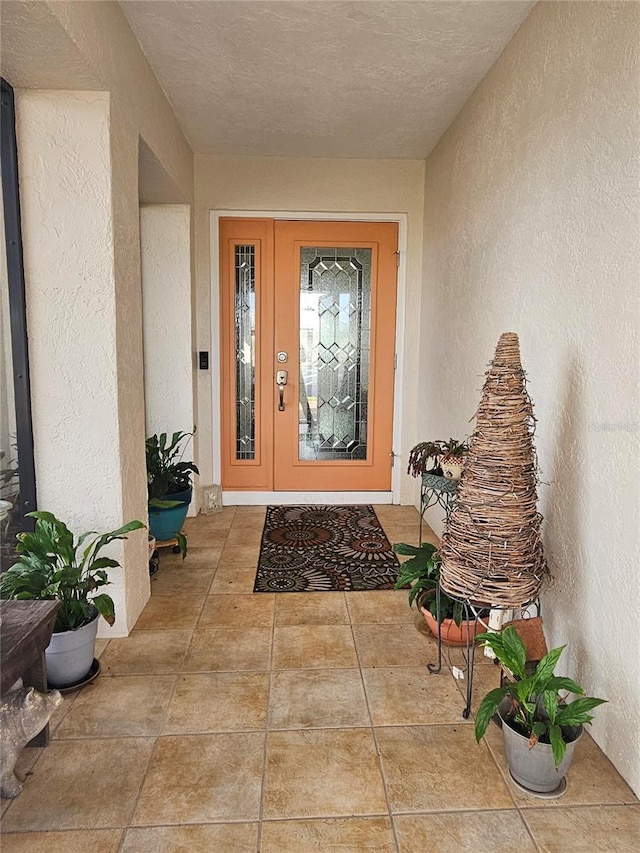 entrance to property featuring stucco siding