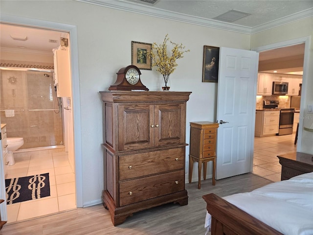 1706 S Lakeside Ct, Venice, FL 34293 - bedroom with visible vents, crown molding, ensuite bathroom, and light tile patterned floors