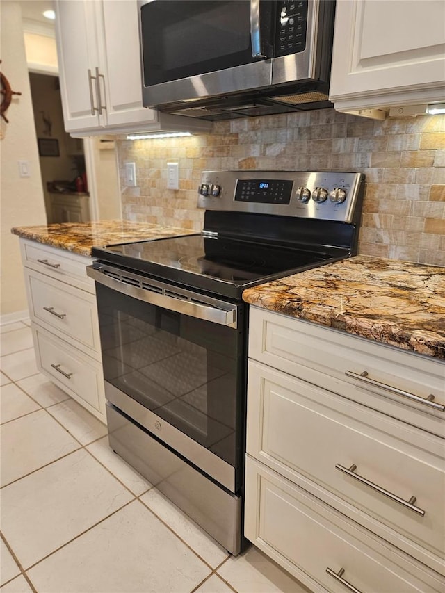 1706 S Lakeside Ct, Venice, FL 34293 - kitchen featuring light stone counters, appliances with stainless steel finishes, and light tile patterned floors