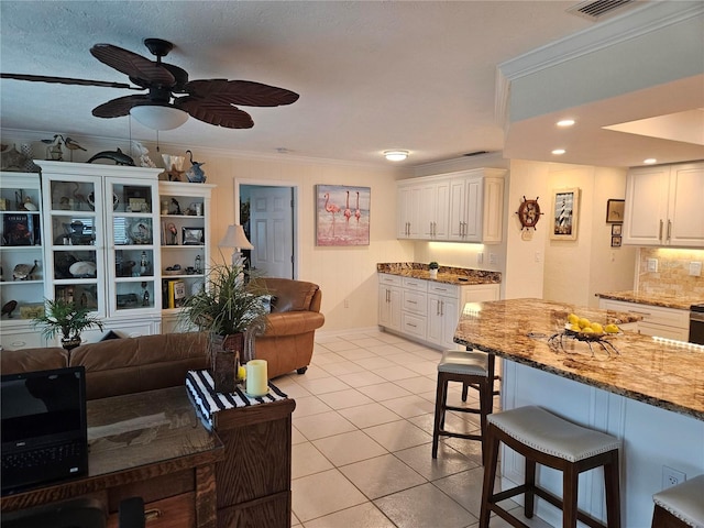 1706 S Lakeside Ct, Venice, FL 34293 - living room with visible vents, crown molding, ceiling fan, recessed lighting, and light tile patterned floors