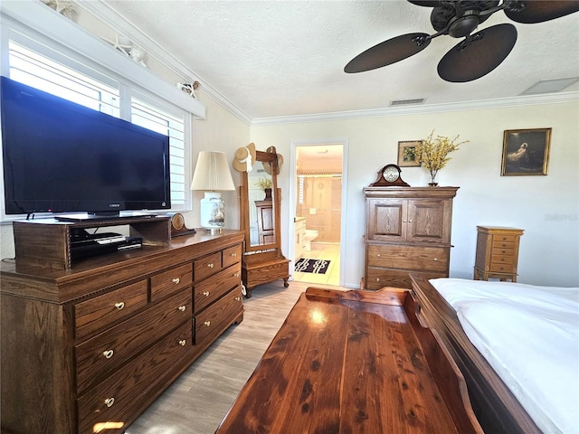 1706 S Lakeside Ct, Venice, FL 34293 - bedroom with a textured ceiling, visible vents, light wood-style flooring, crown molding, and connected bathroom