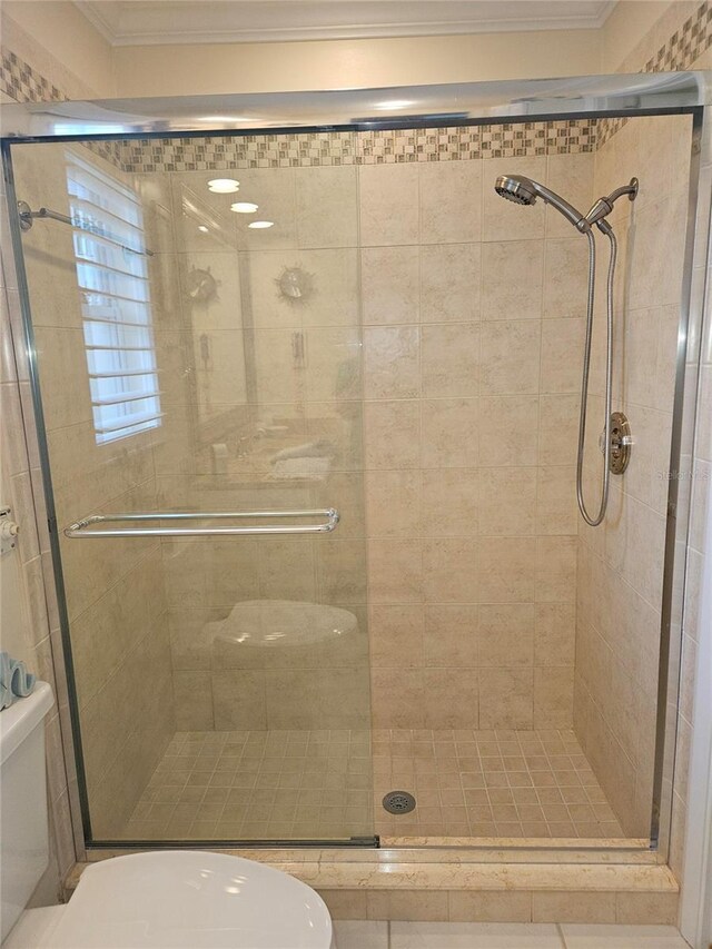 1706 S Lakeside Ct, Venice, FL 34293 - full bathroom featuring toilet, crown molding, and a stall shower