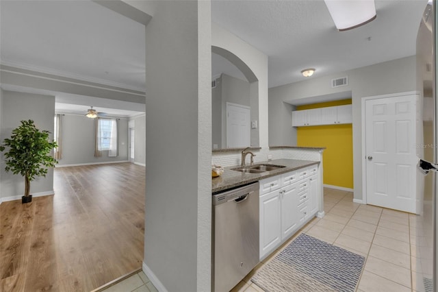 kitchen featuring visible vents, stone countertops, a sink, stainless steel appliances, and white cabinetry