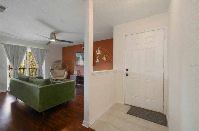 entrance foyer featuring ceiling fan, visible vents, and baseboards