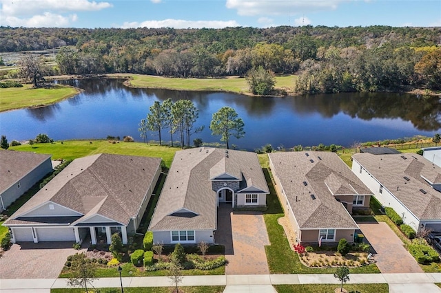 drone / aerial view featuring a water view and a view of trees