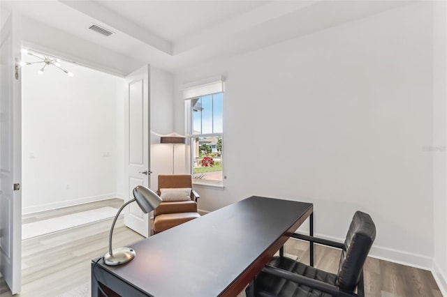 home office with visible vents, baseboards, and wood finished floors