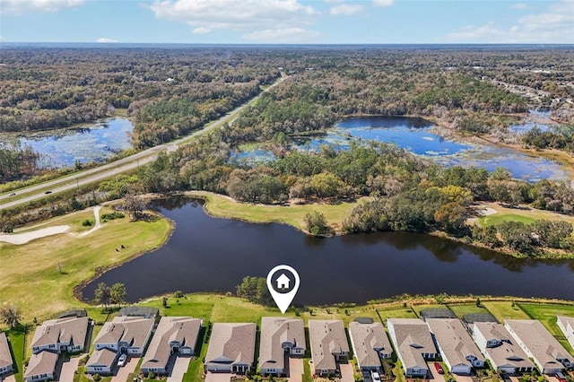 birds eye view of property featuring a water view, a residential view, and a view of trees