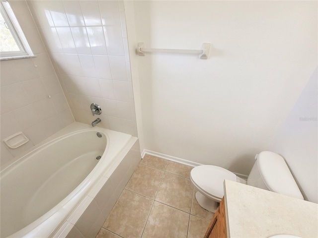 bathroom featuring toilet, tile patterned floors, baseboards, and vanity