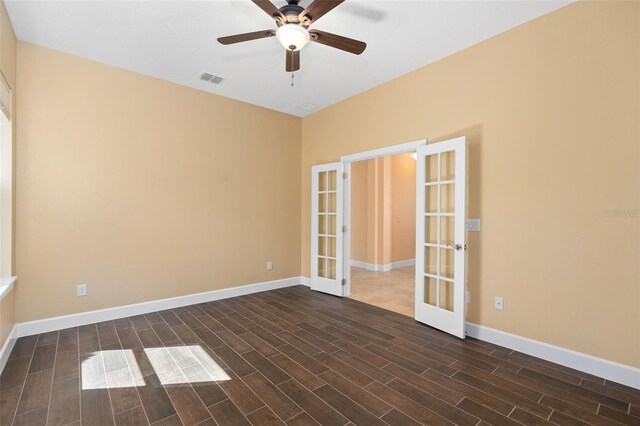 spare room featuring ceiling fan, visible vents, baseboards, french doors, and wood tiled floor