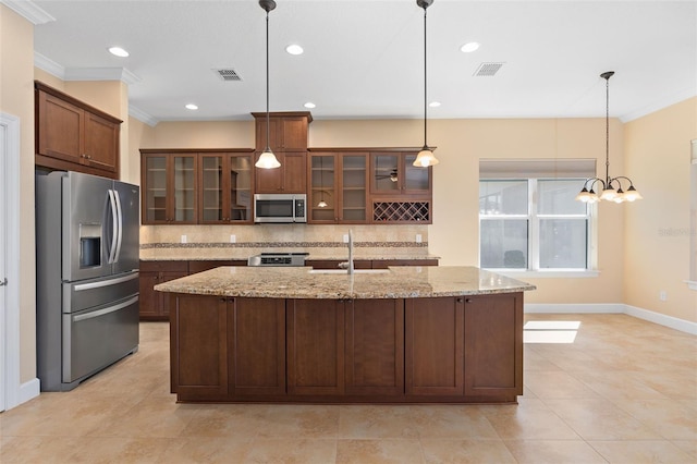 kitchen featuring crown molding, stainless steel appliances, visible vents, backsplash, and a sink