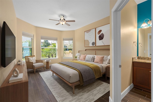 bedroom featuring wood tiled floor, ceiling fan, and baseboards