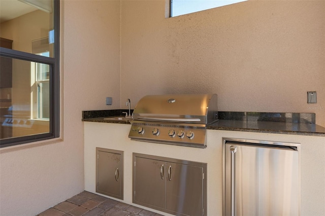 view of patio featuring grilling area, a sink, and area for grilling