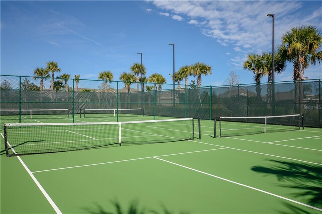 view of tennis court featuring fence