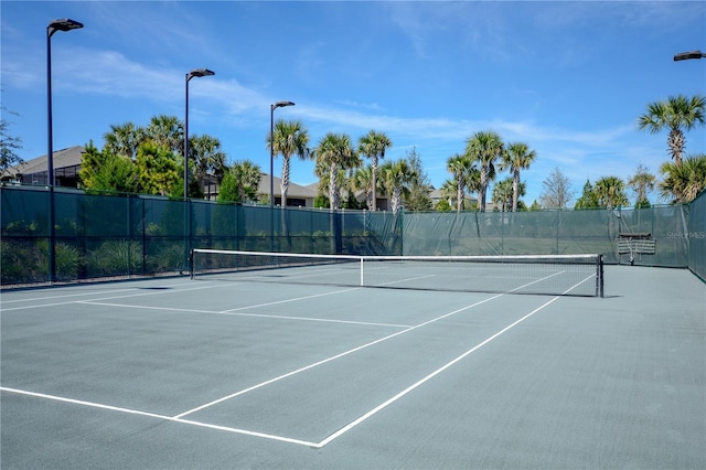 view of tennis court featuring fence