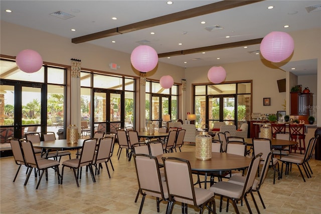 dining space featuring french doors, visible vents, and beamed ceiling