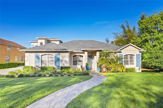 view of front of home featuring a front lawn and stucco siding