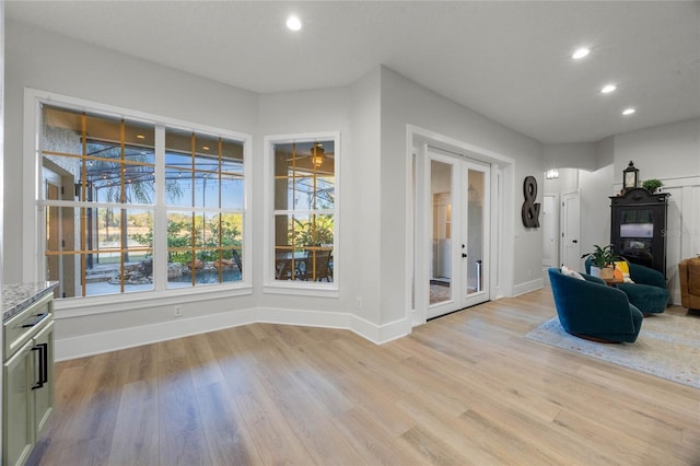 interior space with recessed lighting, light wood-style floors, baseboards, and french doors