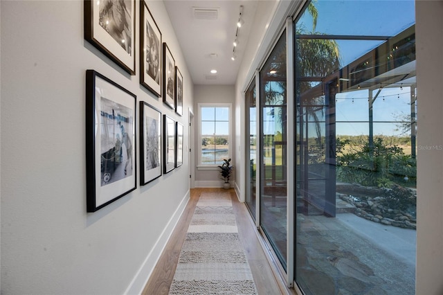 hall with visible vents and baseboards