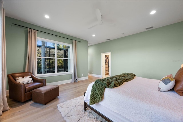 bedroom with light wood-style flooring, recessed lighting, visible vents, and baseboards