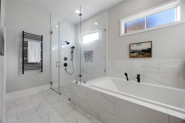 full bath featuring radiator, baseboards, a garden tub, a stall shower, and marble finish floor