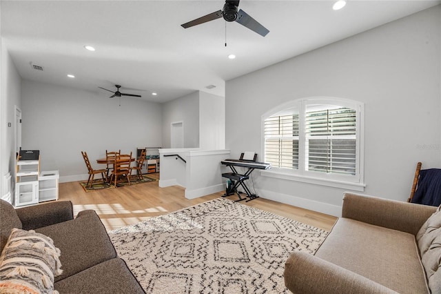 living room featuring wood finished floors, visible vents, baseboards, recessed lighting, and ceiling fan