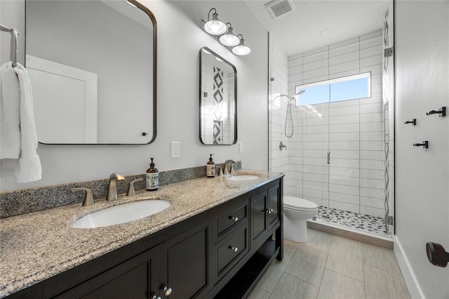 full bath with a sink, visible vents, toilet, and a shower stall