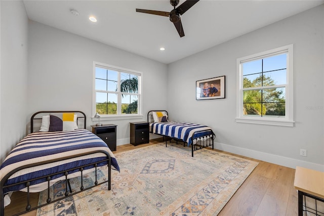 bedroom with recessed lighting, ceiling fan, baseboards, and wood finished floors