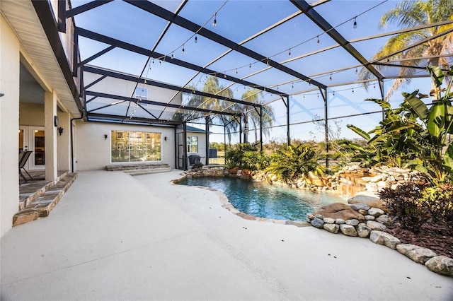 outdoor pool featuring a lanai and a patio area