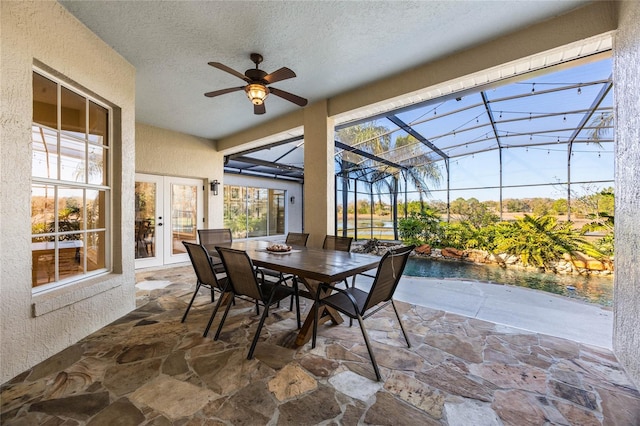 sunroom / solarium with french doors and ceiling fan