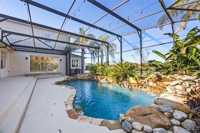 outdoor pool with a lanai and a patio area