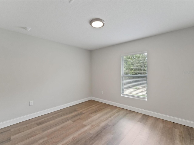 empty room with wood finished floors and baseboards