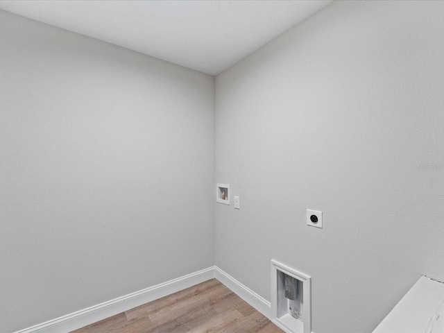 laundry room featuring laundry area, baseboards, hookup for a washing machine, hookup for an electric dryer, and light wood-type flooring