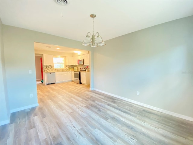 interior space with light wood finished floors, an inviting chandelier, visible vents, and baseboards