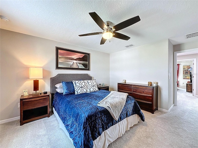 bedroom featuring light carpet, baseboards, visible vents, and ceiling fan