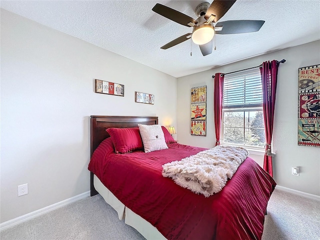 bedroom featuring carpet, baseboards, ceiling fan, and a textured ceiling