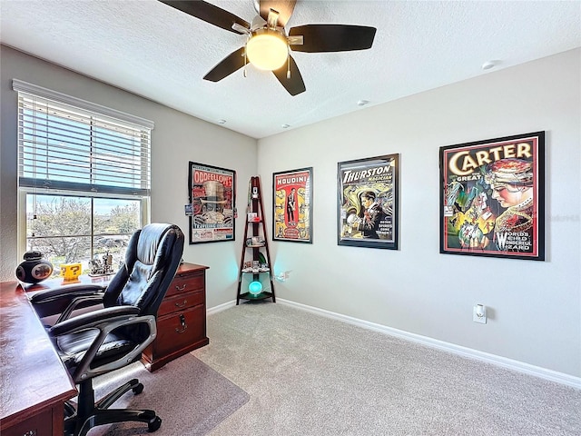 office featuring carpet flooring, ceiling fan, a textured ceiling, and baseboards