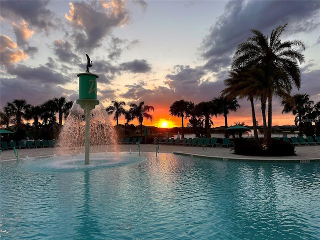 view of pool at dusk