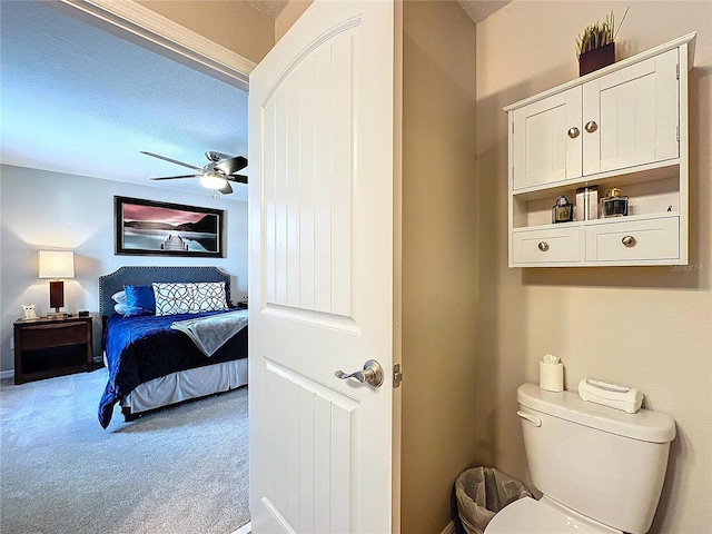 bathroom with a ceiling fan, connected bathroom, and toilet