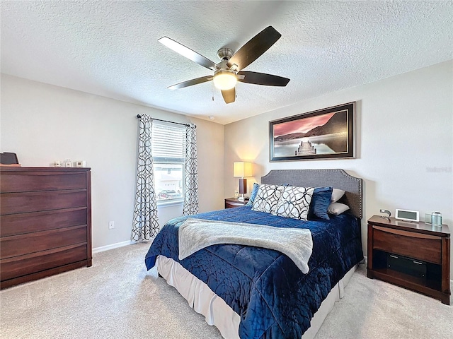 bedroom with carpet flooring, ceiling fan, a textured ceiling, and baseboards