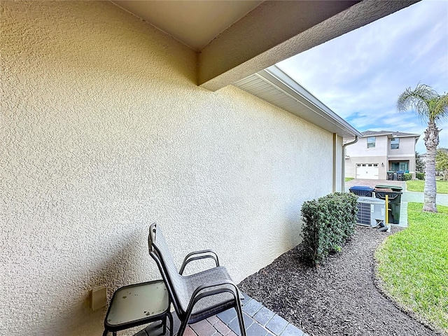 exterior space featuring central air condition unit and stucco siding